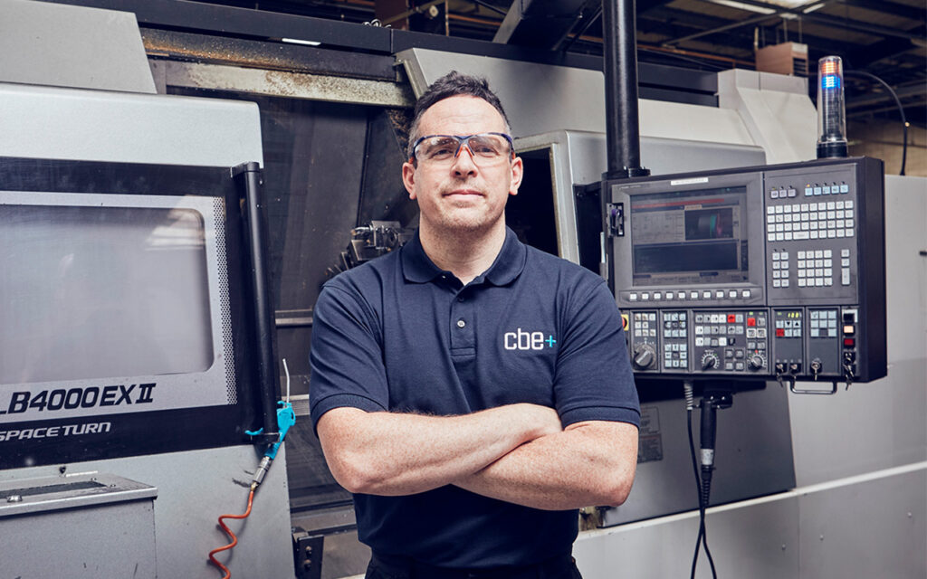 Richard Holdgate posing in front of CNC machine